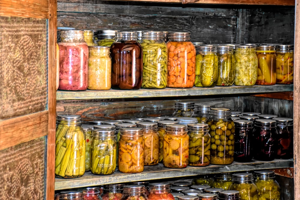 A slate-shelved larder lined with preserve jars