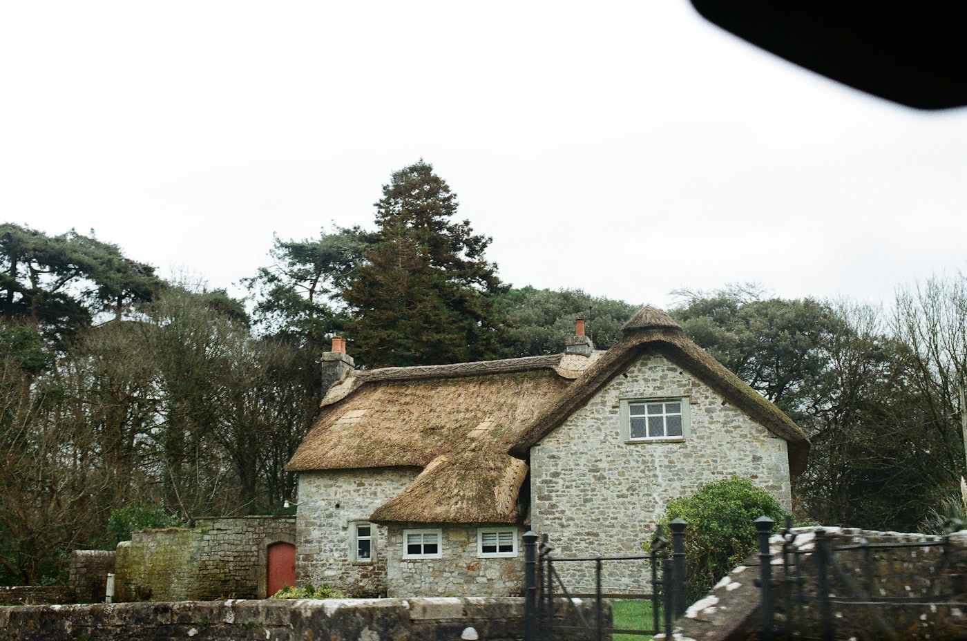 A stone and thatch house in the Marren Vale under a grey sky
